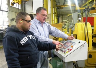 Englert Director of Operations Brian Patrick left and Slitti_filename_1=_ng Leadman Jose Tavarez at the controls